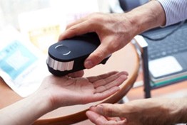 Oligoscan machine being used on a hand