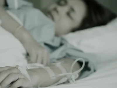 Woman resting in a treatment chair during an IV infusion in a calm clinic room