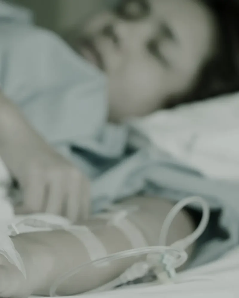 Woman resting in a treatment chair during an IV infusion in a calm clinic room