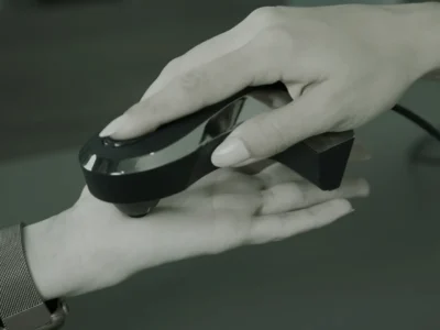 Oligoscan spectrophotometer device being held against the palm of a hand