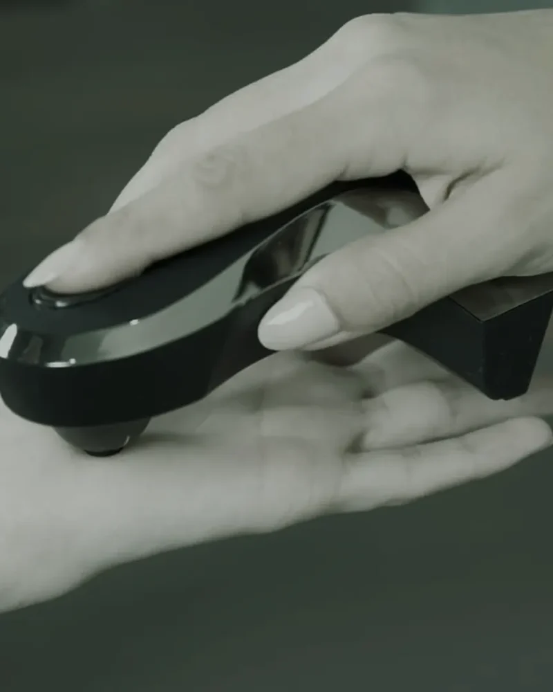 Oligoscan spectrophotometer device being held against the palm of a hand