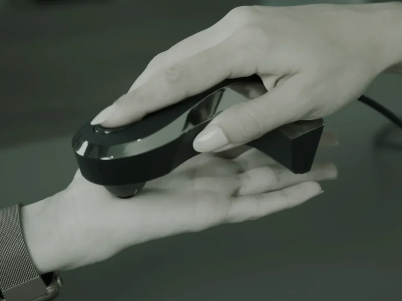 Oligoscan spectrophotometer device being held against the palm of a hand